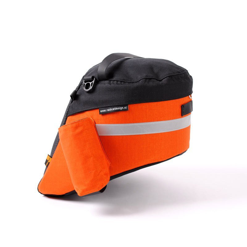 Opposite side view of an orange and black Radical Design Solo Aero Wide recumbent bike bag. Top of bag is black with a black nylon strap, the main body of the bag is orange with a reflective stripe across it and there is a water bottle pouch on this side.