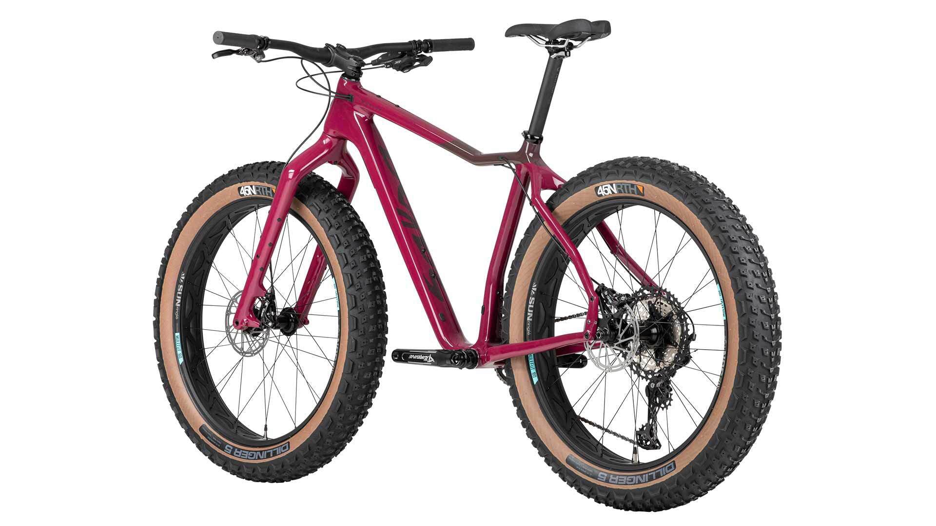 Left profile view of purple Salsa Mukluk fat bike with black accents, black components, and tan sidewall tires on a white background. 