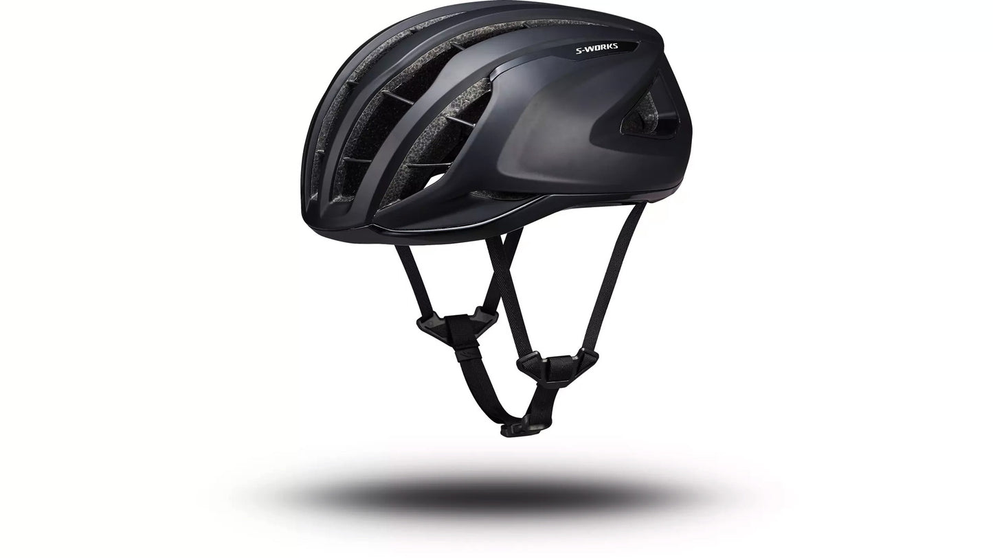 Angled side view of the black Specialized -Works Prevail 3 helmet with adjustable straps and ventilation system against a white background.