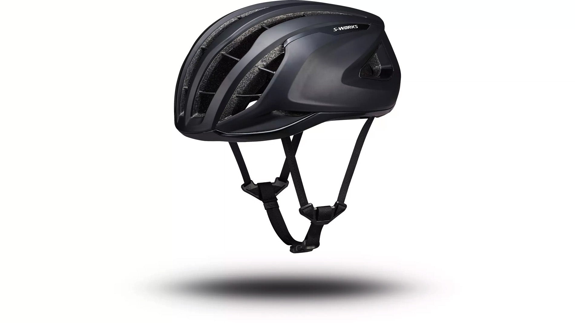 Angled side view of the black Specialized -Works Prevail 3 helmet with adjustable straps and ventilation system against a white background.