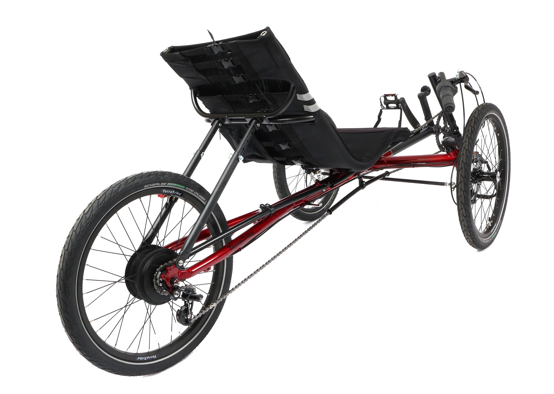 Back angled view of a red and black TerraTrike Traveler recumbent trike with a black seat and folding handlebars, equipped with a chain drive and mechanical disc brakes.