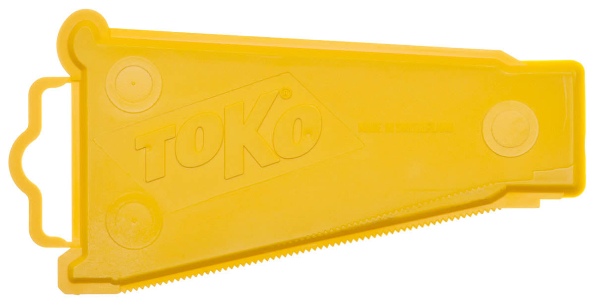 Yellow plastic ski wax scraper with 'Toko' branding on it against a white background.