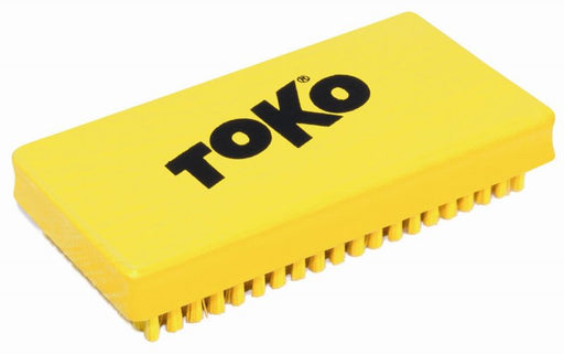 studio view of yellow Toko parafin polishing brush with black TOKO logo on top