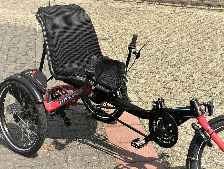 View of Ventisit seat pad installed on a Hast Trigo recumbent trike, outside on a brick patio